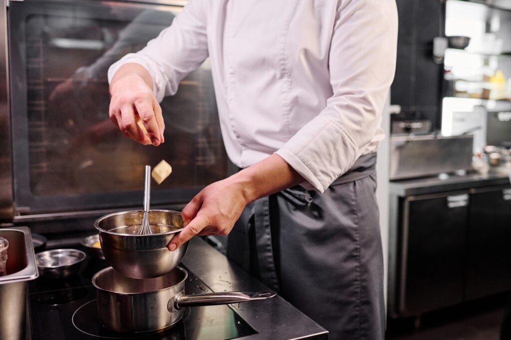 Chef melting butter on cooker