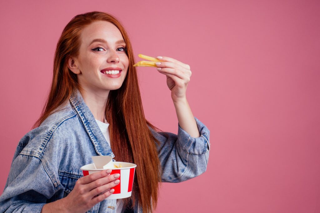 cute red long foxy haired ginger woman holding packaging cardboard box