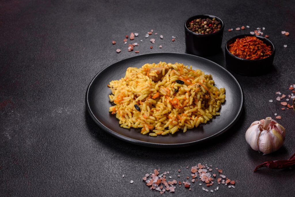 Pilaf with chicken, hot dish of boiled rice, chicken meat and spices
