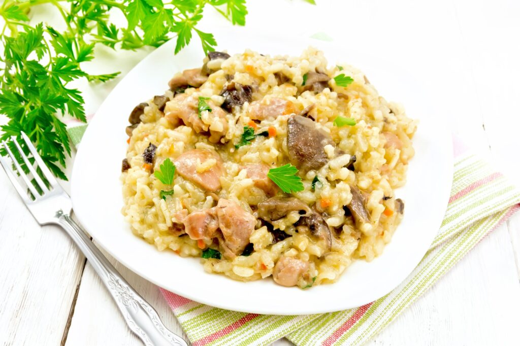 Risotto with mushrooms and chicken on napkin